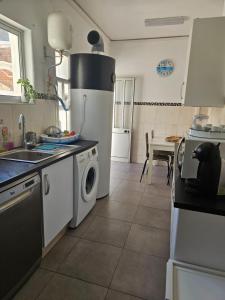 a kitchen with a refrigerator and a washing machine at Lagos Haven Guesthouse in Lagos +62 photos