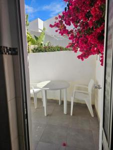 a table and chairs on a balcony with flowers at Lagos Haven Guesthouse in Lagos