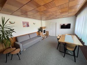 a living room with a couch and a table at Chata Lipa in Bešeňová