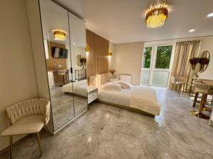 a bedroom with a large bed and a mirror at Baltic Avenue Duo in Klaipėda