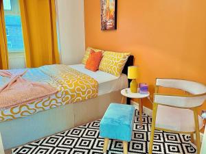 a small bedroom with a bed and a chair at Kaly- Relaxing Garden, Central, Close Parking, near Portsmouth Harbour Train Station, Gunwharf Quays, Southsea in Portsmouth