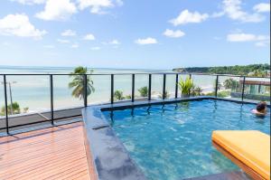 a swimming pool with a view of the beach at Flat Luxo no Setai Edition in João Pessoa