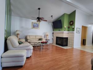 a living room with two couches and a fireplace at Mandarin I95 2 bedrooms Quiet area Backyard in Jacksonville