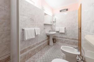a bathroom with a toilet and a sink at Radovčić Apartments and Rooms in Trsteno