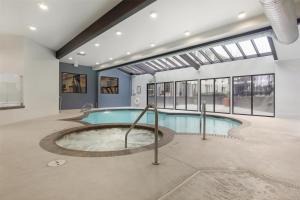 an indoor pool with a hot tub in a building at Best Western Seattle Airport Hotel in SeaTac
