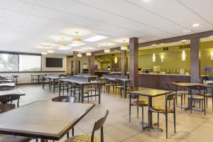 a restaurant with tables and chairs and a bar at Best Western Seattle Airport Hotel in SeaTac