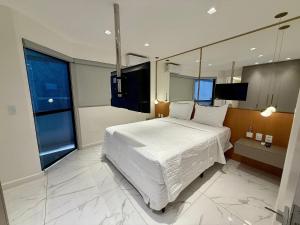 Giường trong phòng chung tại Edifício Tenerife - 607 Mandi Hospitalidade +28 ảnh