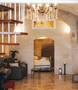 a living room with a couch and a bed at Bellavita Rooms- Isabel luxury Suite in Matera