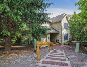 a home with a bench in front of a house at Mountainview Vista 1 Mile To Water Park & Ski in Tannersville