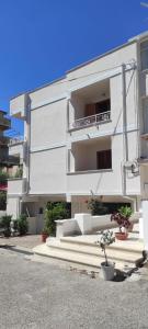 a white apartment building with stairs in front of it at Case Vacanze Tropea La Pinnata in Tropea