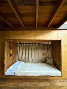 a bed in a wooden frame in a room at Tití Bungalows in Tarapoto +14 photos
