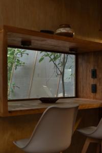 a window in a room with a table and a chair at Tití Bungalows in Tarapoto