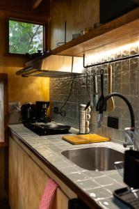 a kitchen with a sink and a counter top at Tití Bungalows in Tarapoto