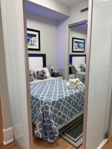 a bedroom with a bed and a large mirror at Downtown Toronto Condo with CN Tower View in Toronto