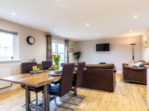 a living room with a table and a couch at 2 Bed in South Molton 78097 in South Molton
