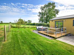 a boat on a dock next to a house at 2 Bed in South Molton 78097 in South Molton