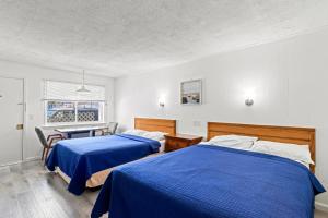 Ένα ή περισσότερα κρεβάτια σε δωμάτιο στο Sea Garden Motel