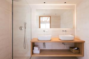a bathroom with two sinks and a mirror at Malacosta Sky Suites - MC Apartments Ibiza in Ibiza Town +38 photos