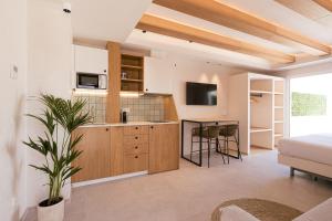 a bedroom with a bed and a kitchen with a table at Malacosta Sky Suites - MC Apartments Ibiza in Ibiza Town