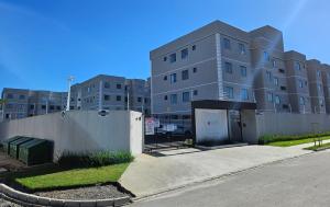 a large building with a garage in front of it at Studio 306, decorado com garagem e ar-condicionado in Paranaguá