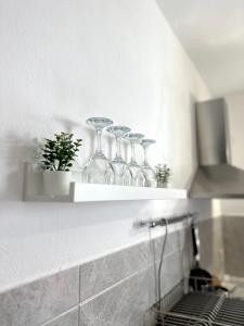 a row of wine glasses on a shelf in a kitchen at Le Terrazze - Holiday Home near the Beach in Monterosso al Mare