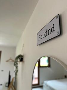 a sign that reads be kind hanging on a wall at Le Terrazze - Holiday Home near the Beach in Monterosso al Mare +13 photos