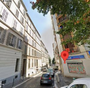 a street with cars parked on the side of a building at Studio Gare Saint Charles in Marseille