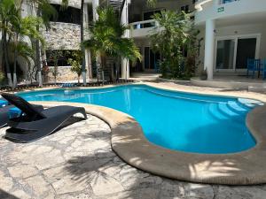 a swimming pool with a slide next to a building at blue angel 3 in Playa del Carmen