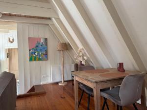 a dining room with a wooden table and chairs at Loft - Stadsplekje in Schagen