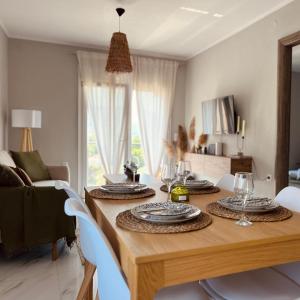 a dining room table with plates and glasses on it at Anemelia Apartments in Limenas +11 photos
