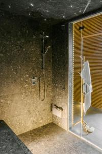 a bathroom with a shower with a glass door at Hôtel Monroe - Downtown Montreal in Montreal +52 photos
