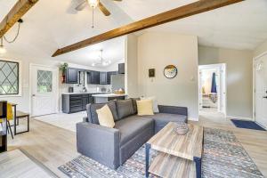 a living room with a couch and a table at Pool and Lake Access Family Poconos Cabin with Deck in Tobyhanna