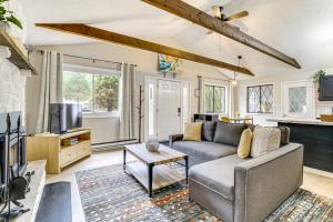 a living room with a couch and a tv at Pool and Lake Access Family Poconos Cabin with Deck in Tobyhanna