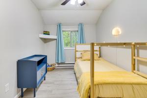 a bedroom with two beds and a tv in it at Pool and Lake Access Family Poconos Cabin with Deck in Tobyhanna +21 photos