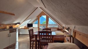 a kitchen and dining room with a table and chairs at Apartments Čebelica in Bohinj