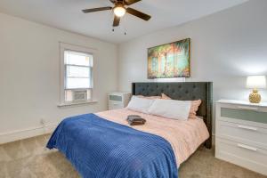 a bedroom with a bed with a blue blanket and a ceiling fan at Luxurious 2BR Kansas City Condo Near Downtown in Kansas City