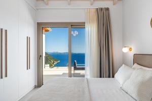 a bedroom with a bed and a view of the ocean at Calliste Villa in Évyiros +63 photos