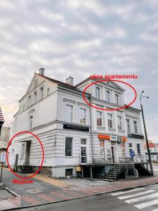 a large white building with a red circle around it at Apartament Pastelowy Kwidzyn in Kwidzyn