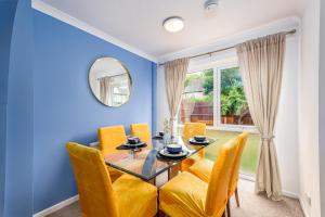 a dining room with a glass table and yellow chairs at Summer Deal 20 PRC OFF 4BR 2BATH Families Groups By Trinity Stays Short Lets & Serviced Accommodation Cambridge in Cambridge