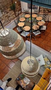 a group of tables and chairs with straw umbrellas at Casa Rural Arco Navarra in Artariáin