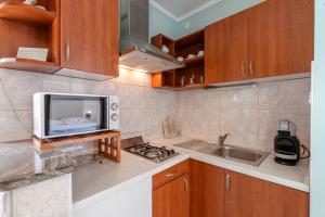 a kitchen with a microwave and a sink at Radovčić Apartments and Rooms in Trsteno +49 photos