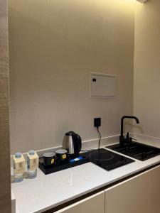 a kitchen with a stove top with a tea kettle at Regency View Hotel in Al Madinah +19 photos