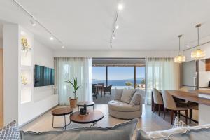 a living room with a table and a dining room at Calliste Villa in Évyiros