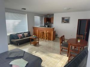 a living room with a couch and a table at Апартамент Енигма in Sveti Vlas