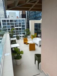 a balcony with tables and chairs on a building at Espectacular apartamento en Obarrio in Panama City +5 photos