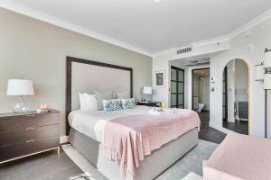 a bedroom with a large bed with a pink blanket at MVR-Bask in Luxury-Right in Coconut Grove in Miami