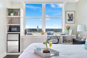 a room with a bed with a tray of fruit on it at MVR-Bask in Luxury-Right in Coconut Grove in Miami +22 photos