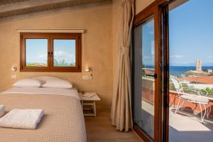 a bedroom with a bed and a balcony at Delmare Tower View Suites in Nea Fokea +101 photos