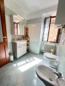 a bathroom with a sink and a toilet at Da Mamaa casa vacanze in Toceno