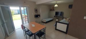 a living room with a table and a dining room at M&P alquiler por día in La Rioja